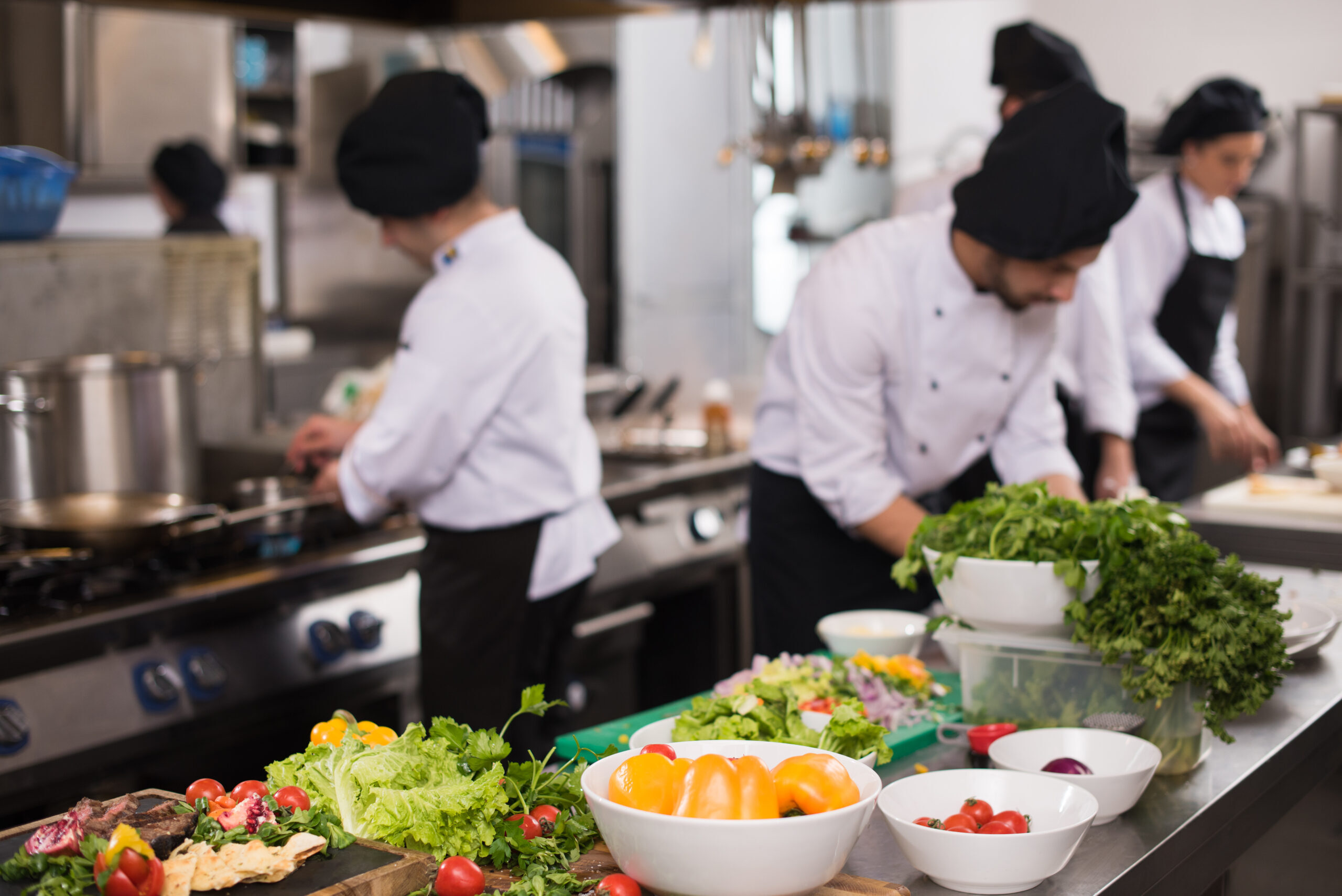 professional-team-cooks-and-chefs-preparing-meals-at-busy-hotel