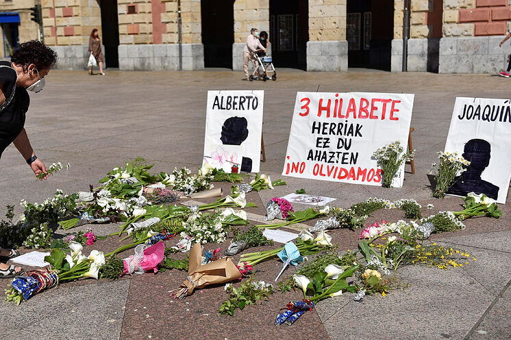 Una mujer coloca flores frente al consistorio de Eibar (Guip