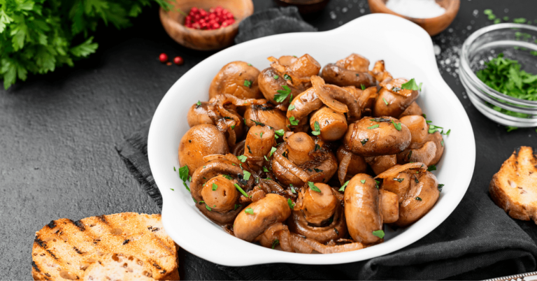 Button mushrooms in a white bowl