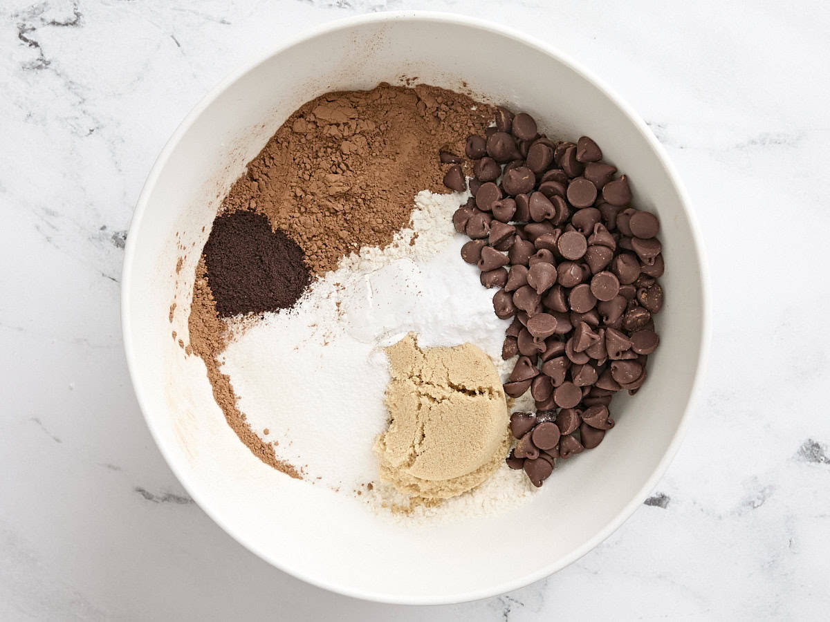 Café instantané, cassonade, sucre granulé, farine et pépites de chocolat dans un bol à mélanger.