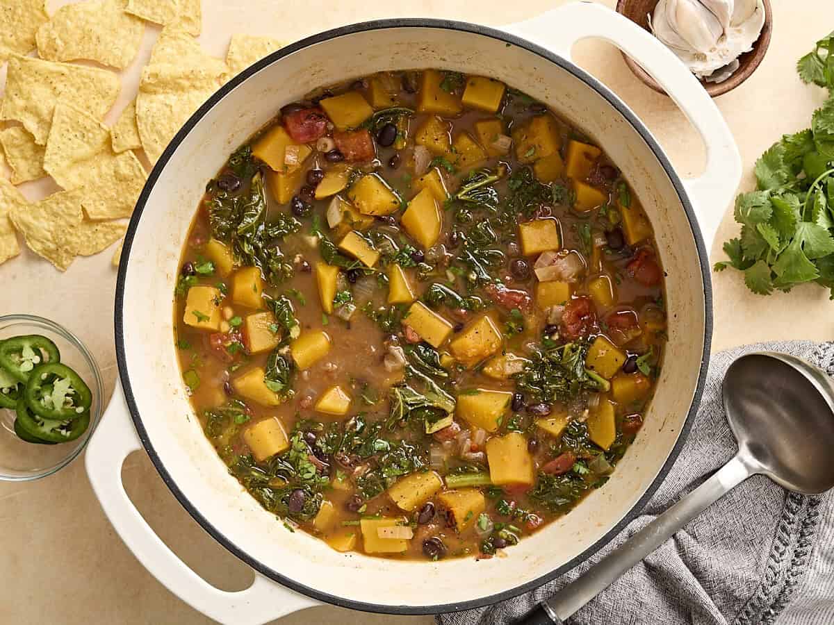 Vue aérienne de la courge musquée et de la soupe aux haricots noirs dans une cocotte.