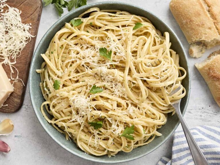 Overhead view of a plate of fettuccine alfredo with a fork.