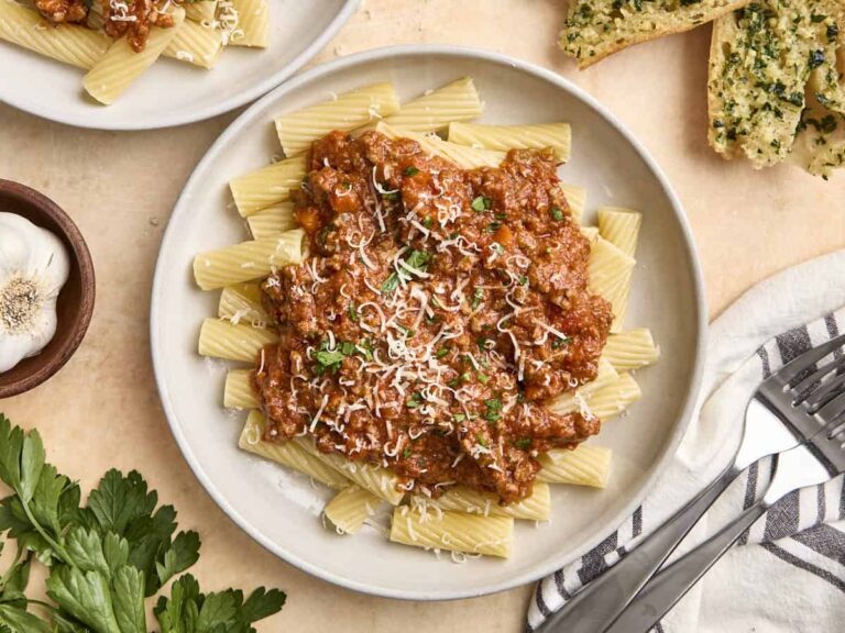 Overhead view of a plate of bolognese sauce and pasta.