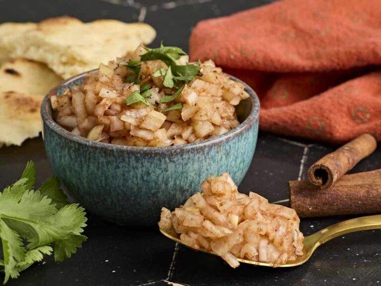 Side view of a bowl of homemade onion chutney.
