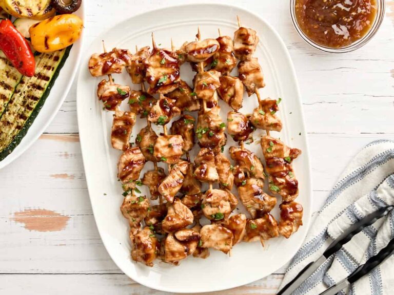 Overhead view of grilled teriyaki skewers on a platter.