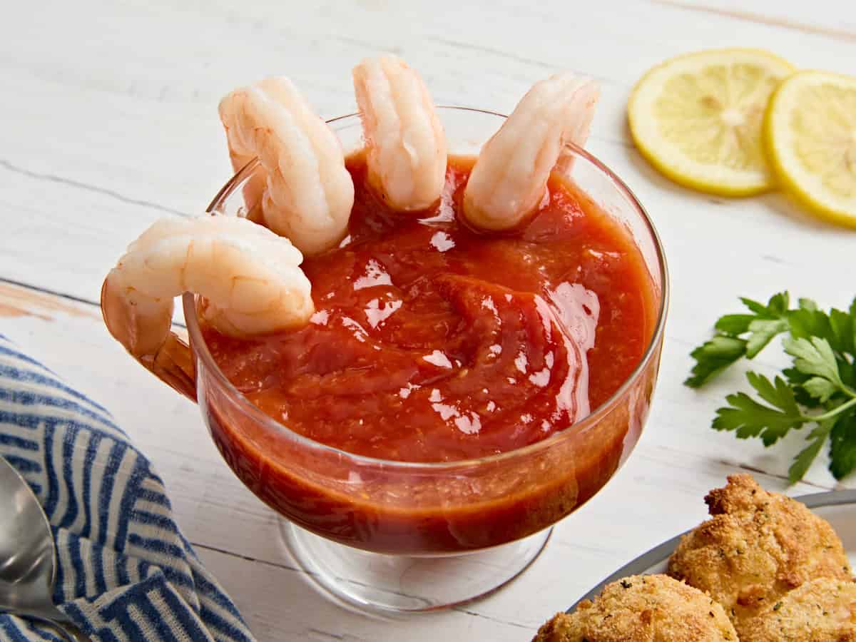 Side view of seafood sauce in a bowl with shrimp.