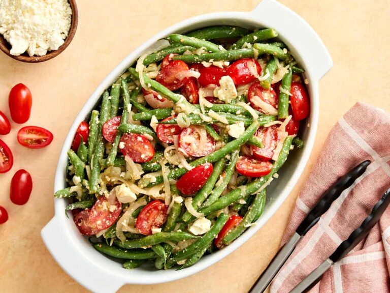 Overhead view of a green bean salad in a serving dish.