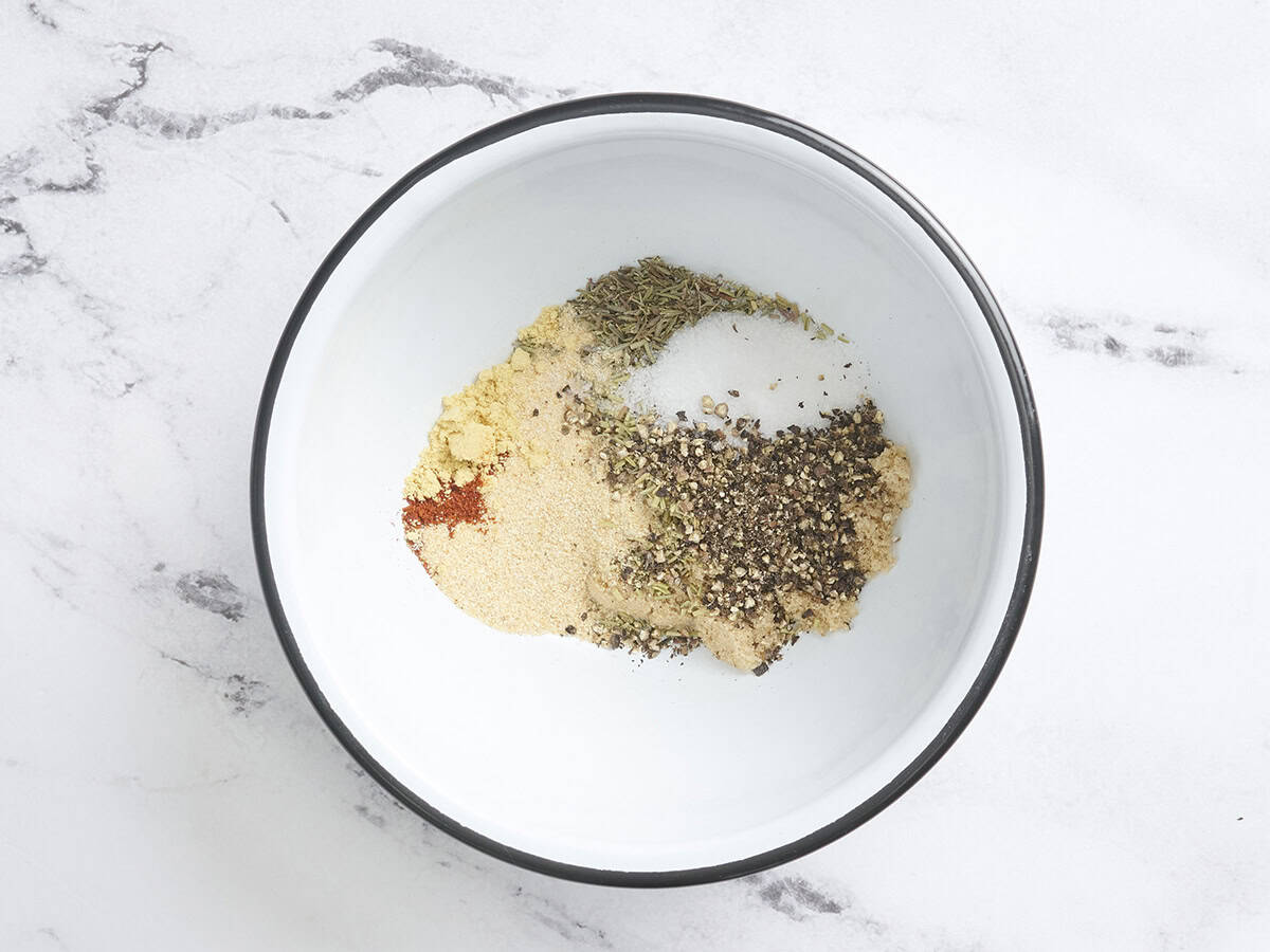 Sucre, sel, poivre et herbes séchées dans un bol à mélanger pour faire un steak sèche frotter pour les steaks tendres surlongers grillés.