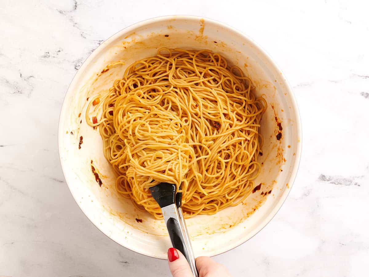 Nouilles Dan Dan mélangées à de la sauce dans un bol.