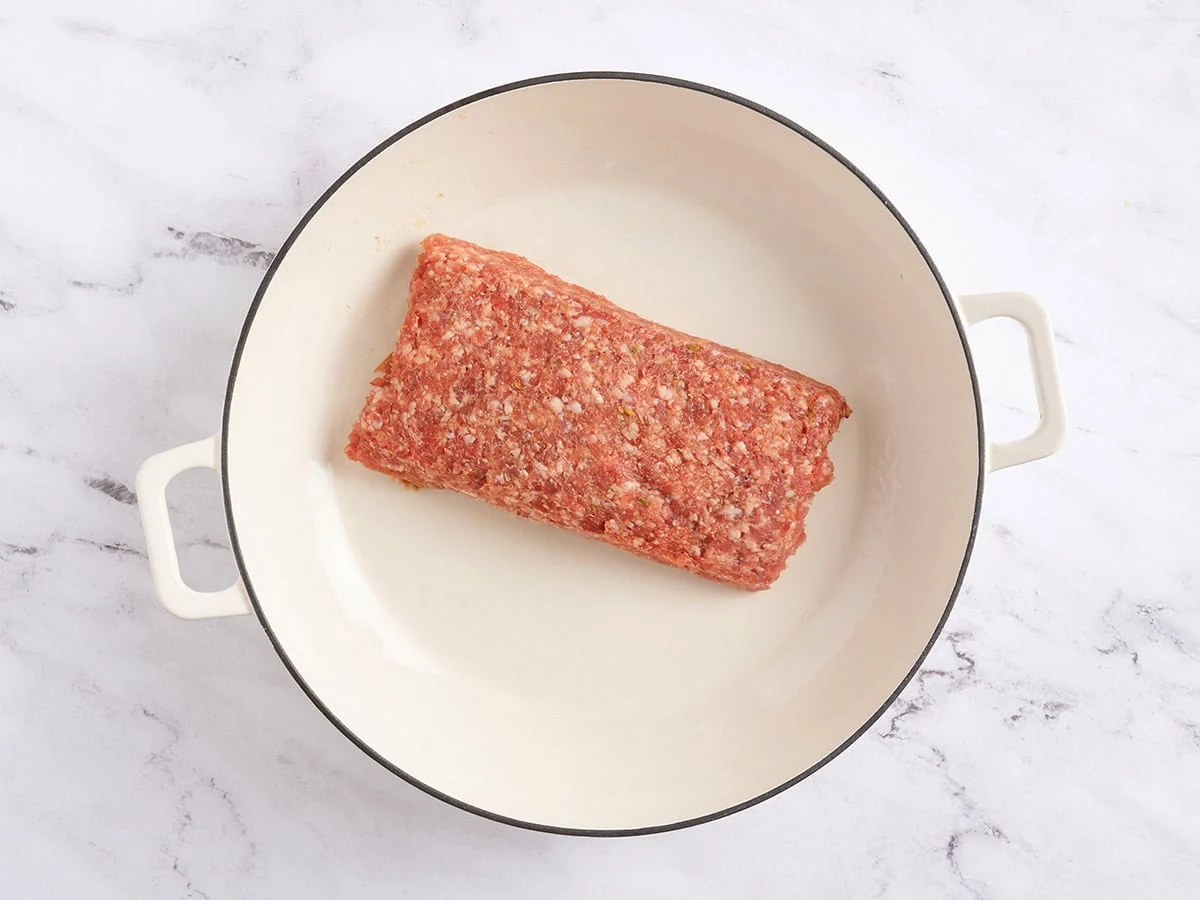 Saucisse italienne hachée dans une poêle.