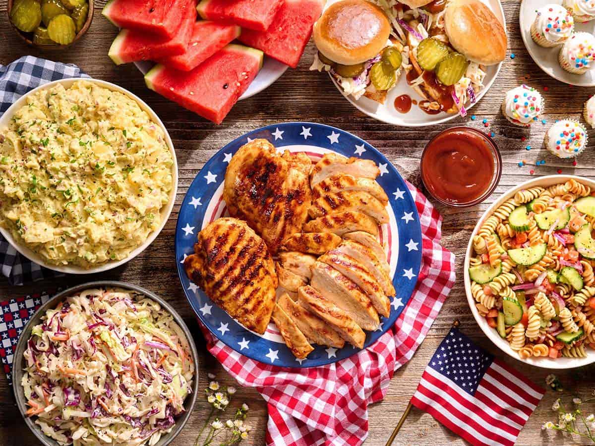 Overhead view of a 4th of July cookout table spread.