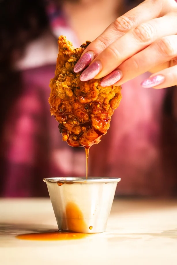 Close up de poulet frit trempé dans la sauce